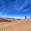 Load image into Gallery viewer, KapiK1 Expedition Co | KapiK1 Co-Founder Ray Zahab having fun on sand dunes after his mid day coffee.